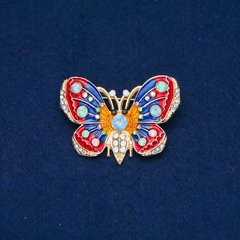 Брошка Метелик золотистий метал, емаль і білі, блакитні, салатові, рожеві стрази 30х45мм + - купити біжутерію