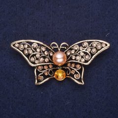 Брошка Метелик з жовтими каменями і перловою намистиною 55х25мм жовтий метал купити біжутерію дешево в